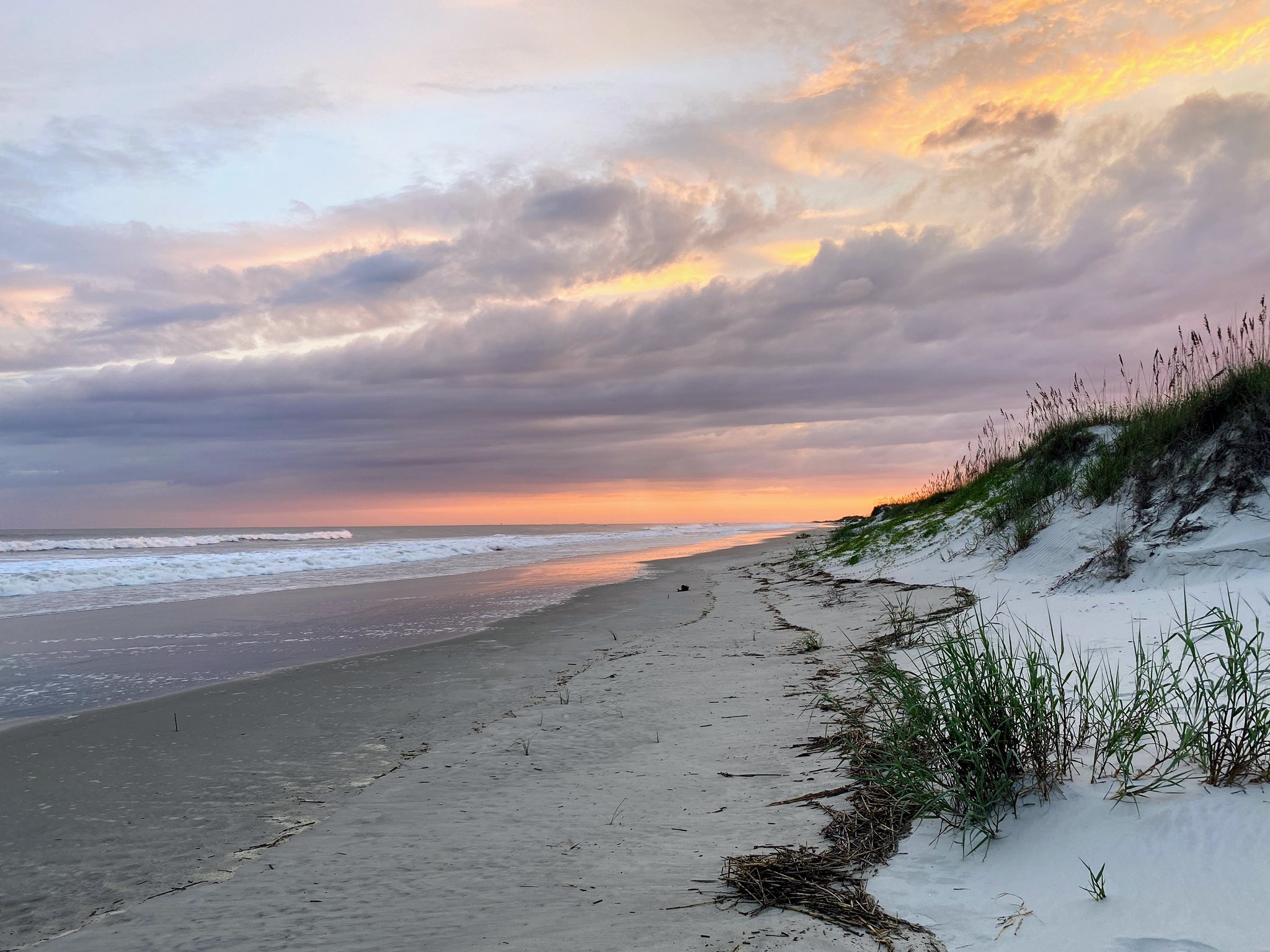 Wide, unspoiled Sunset Beach strand at dusk