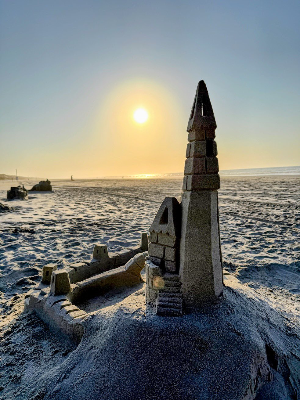 Sand castle at sunset on the beach