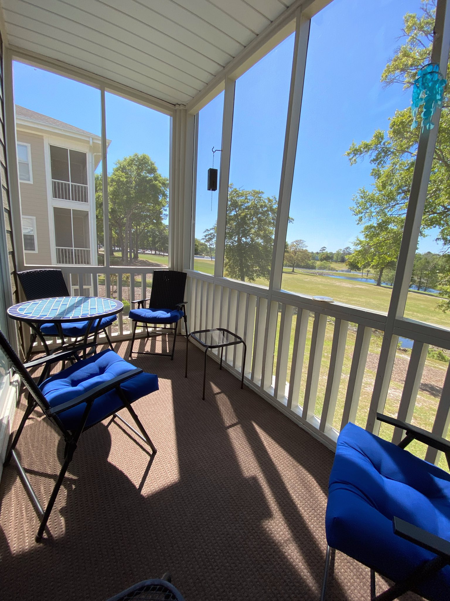 Screened back porch overlooking the golf course
